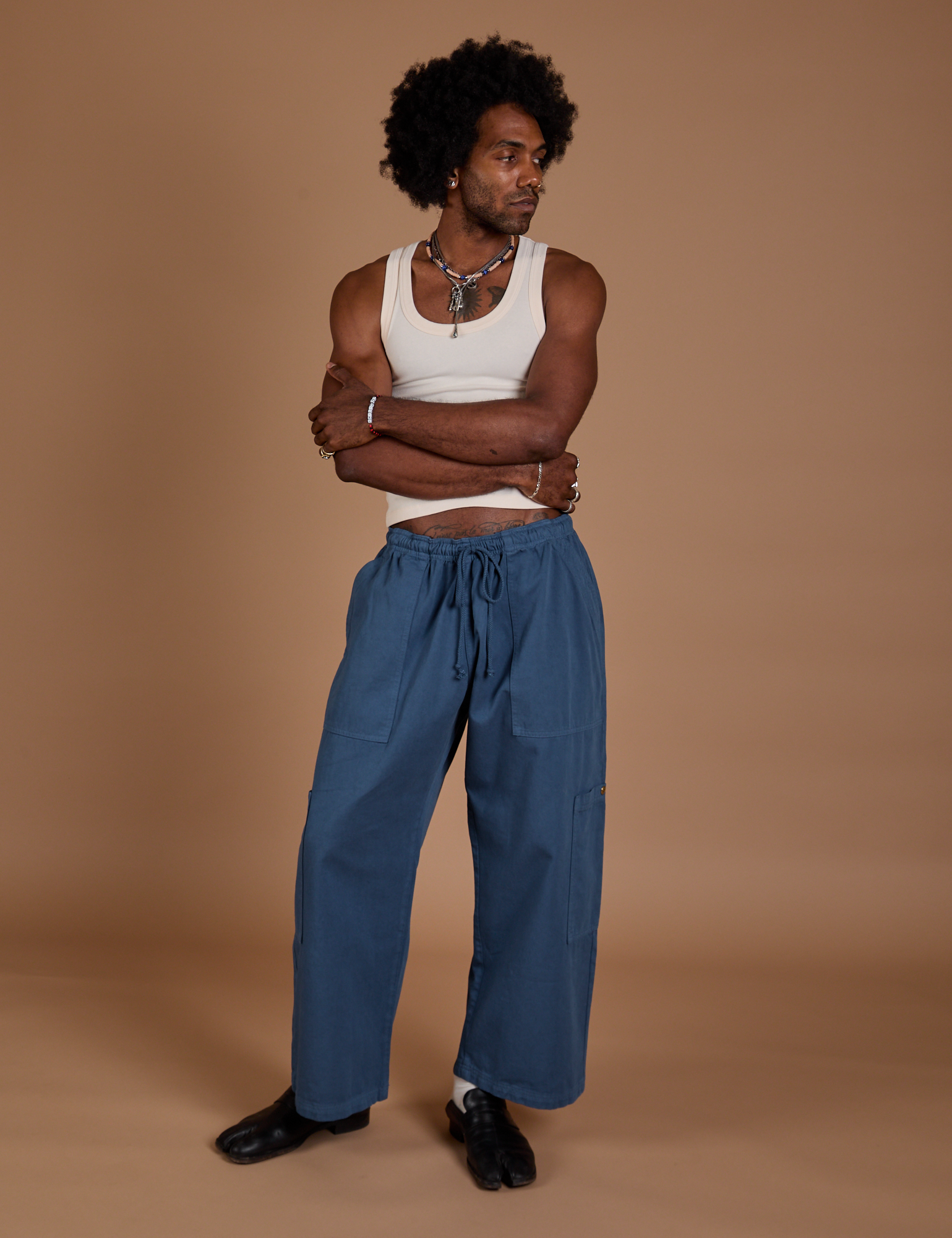 Jerrod is 6’3” and wearing M Drop Pocket Cargo Pants in French Blue paired with a Tank Top in vintage tee white