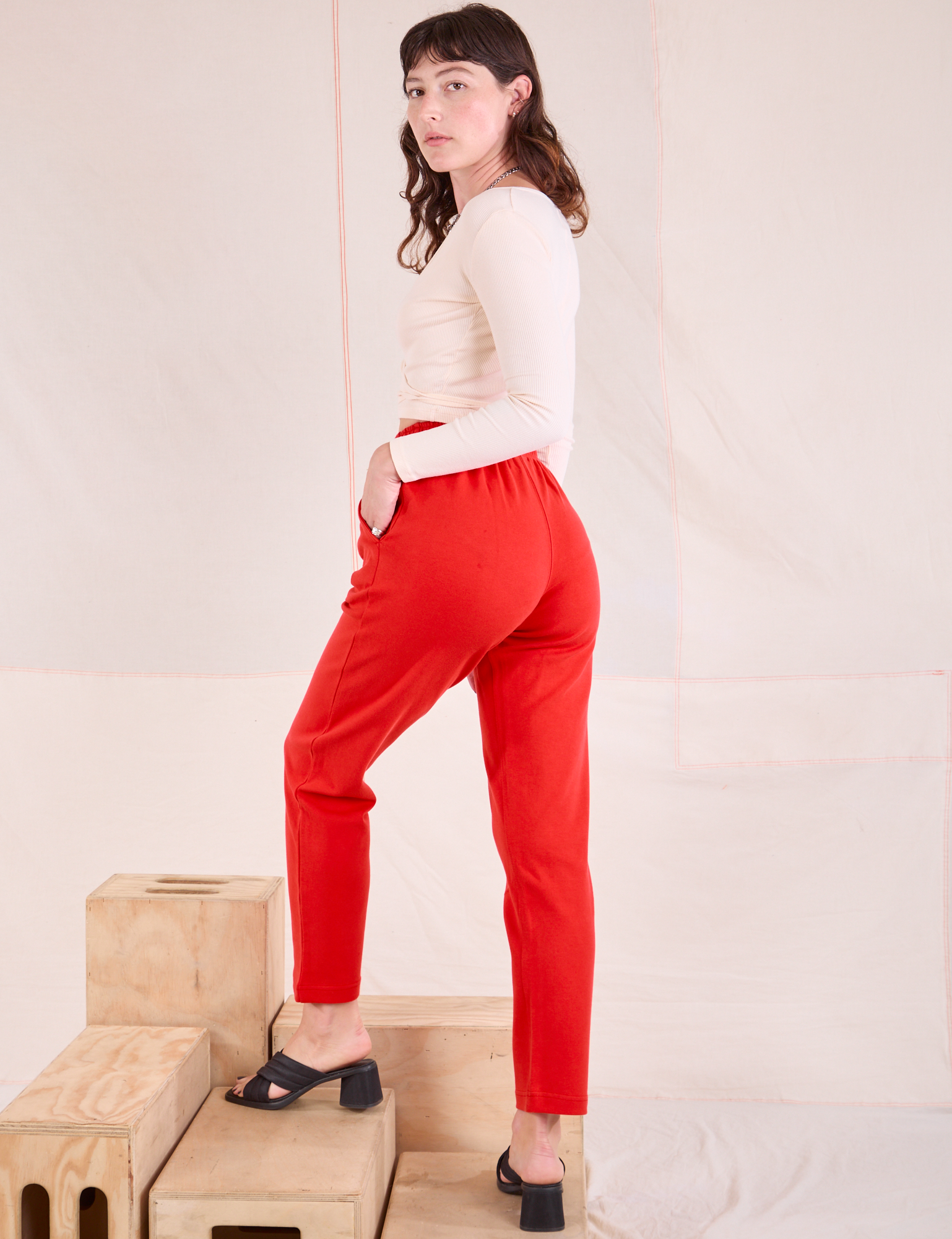 Easy Pants in Mustang Red angled back view on Alex