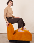 Side view of Work Pants in Espresso Brown on Soraya wearing tan Essential Turtleneck.