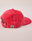 Side view of Dugout Corduroy Hat in Hot Pink. Big Bud label sewn on the side.