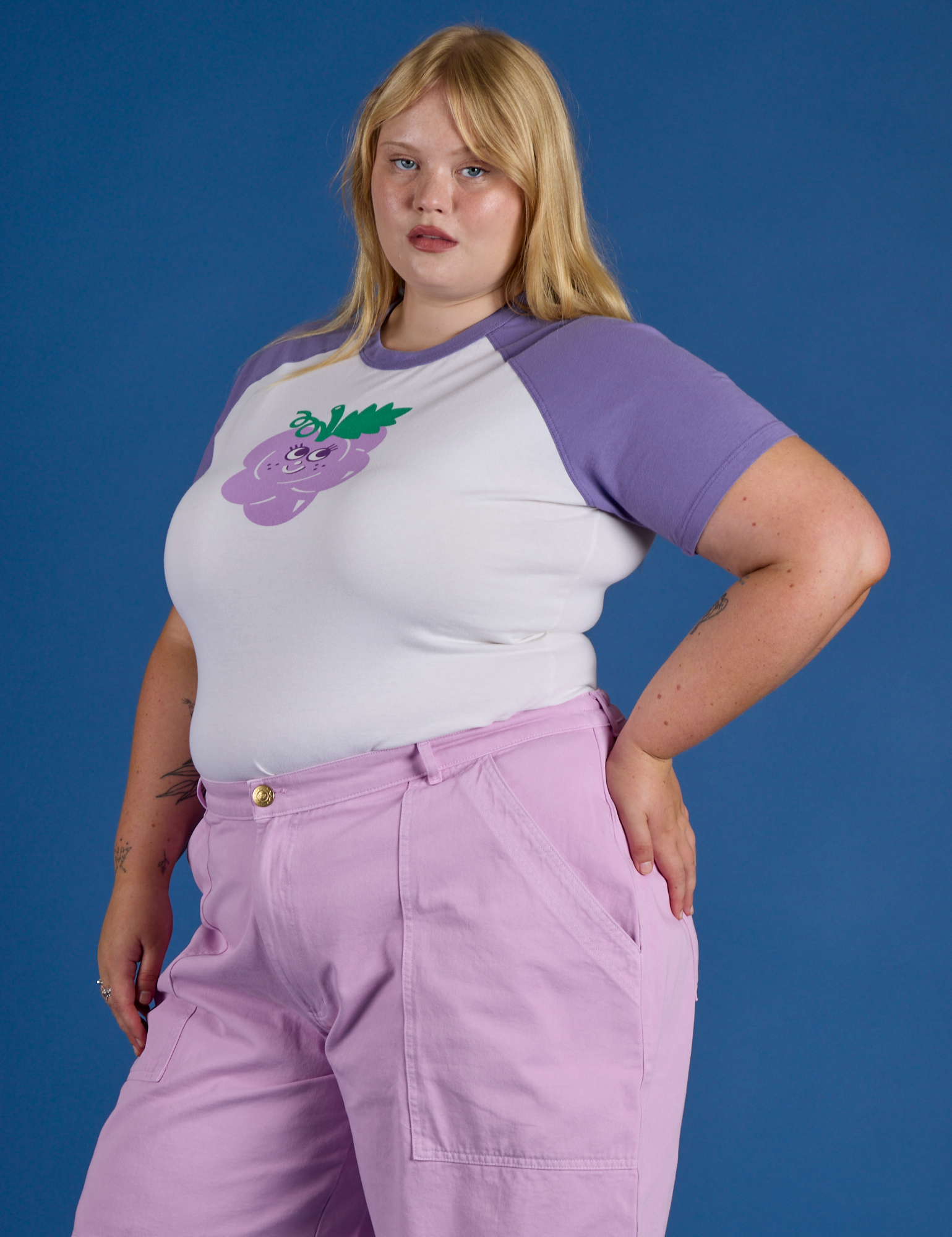 Angled front view of Produce Raglan Tee in Grape on Juliet