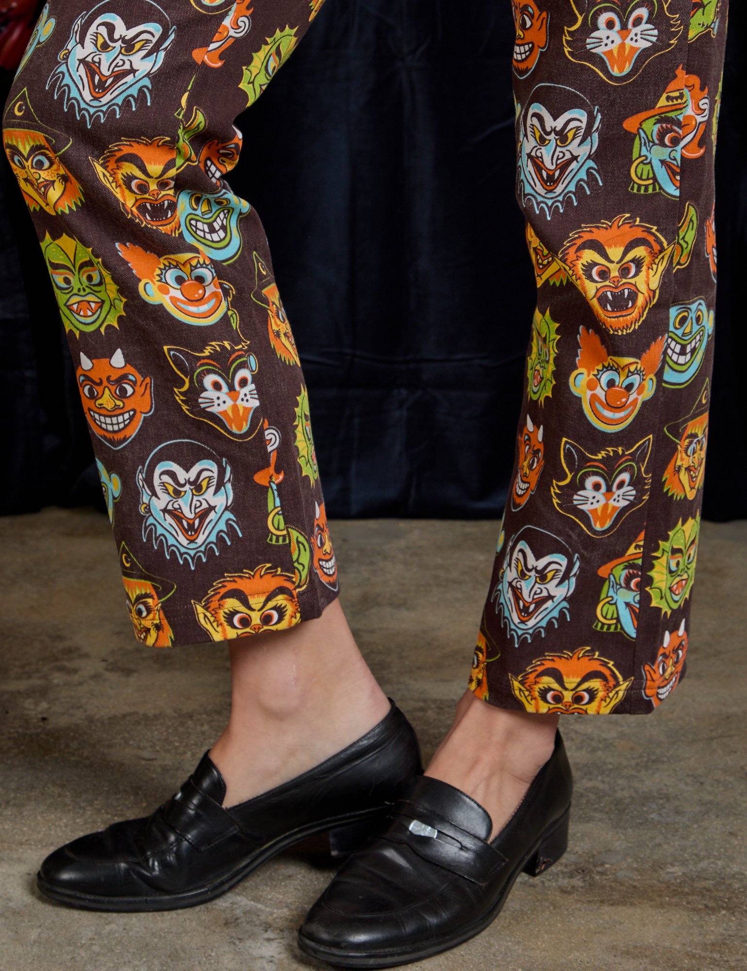 Short Sleeve Jumpsuit in Halloween Masks pant leg close up on Alex