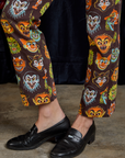 Short Sleeve Jumpsuit in Halloween Masks pant leg close up on Alex