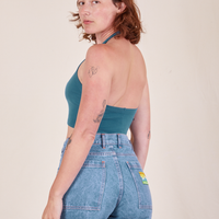 Angled back view of Halter Top in Marine Blue and light wash Frontier Jeans worn by Alex