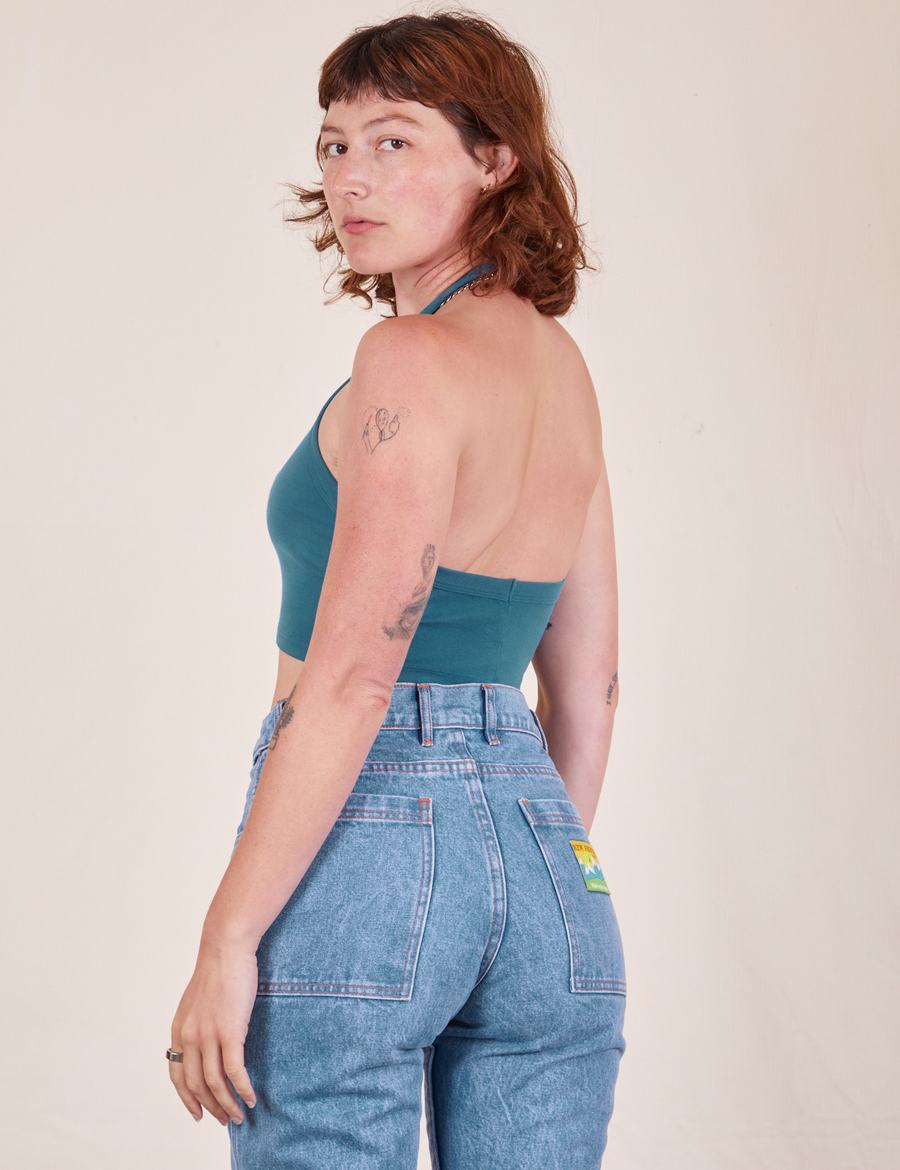 Angled back view of Halter Top in Marine Blue and light wash Frontier Jeans worn by Alex