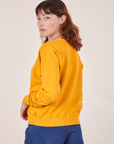 Back angled view of Heavyweight Crew in Mustard Yellow on Alex