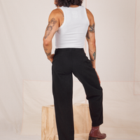 Back view of Heavyweight Trousers in Basic Black and vintage off-white Cropped Tank Top worn by Jesse