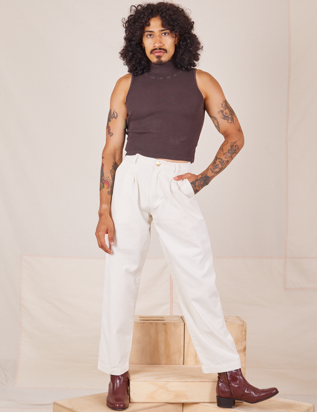 Jesse is 5'8" and wearing XXS Heavyweight Trousers in Vintage Off-White and espresso brown Sleeveless Turtleneck.