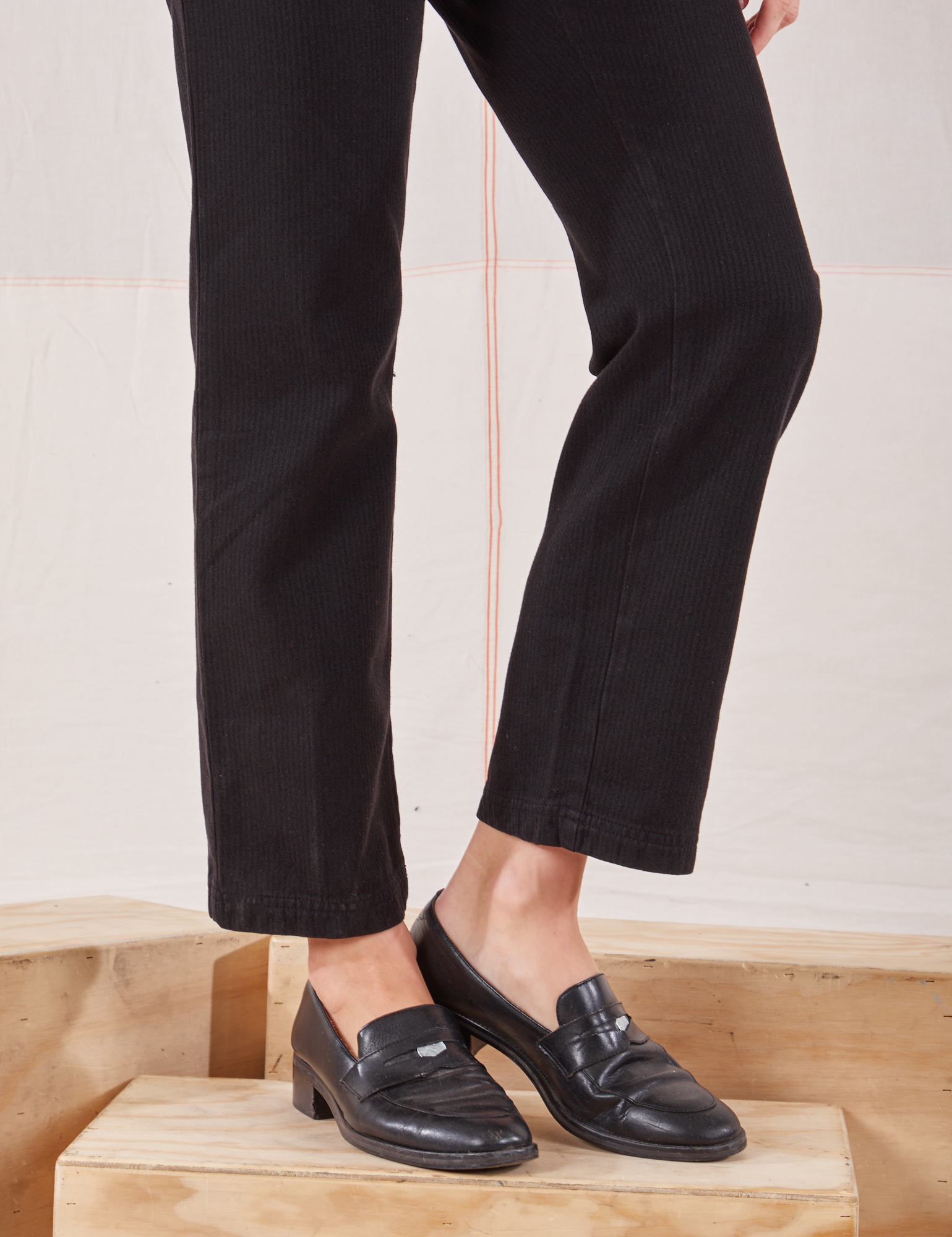 Heritage Short Sleeve Jumpsuit in Basic Black pant leg close up on Alex