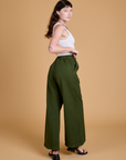 Angled back view of Heritage Wide Leg Trousers in Evergreen on Alex