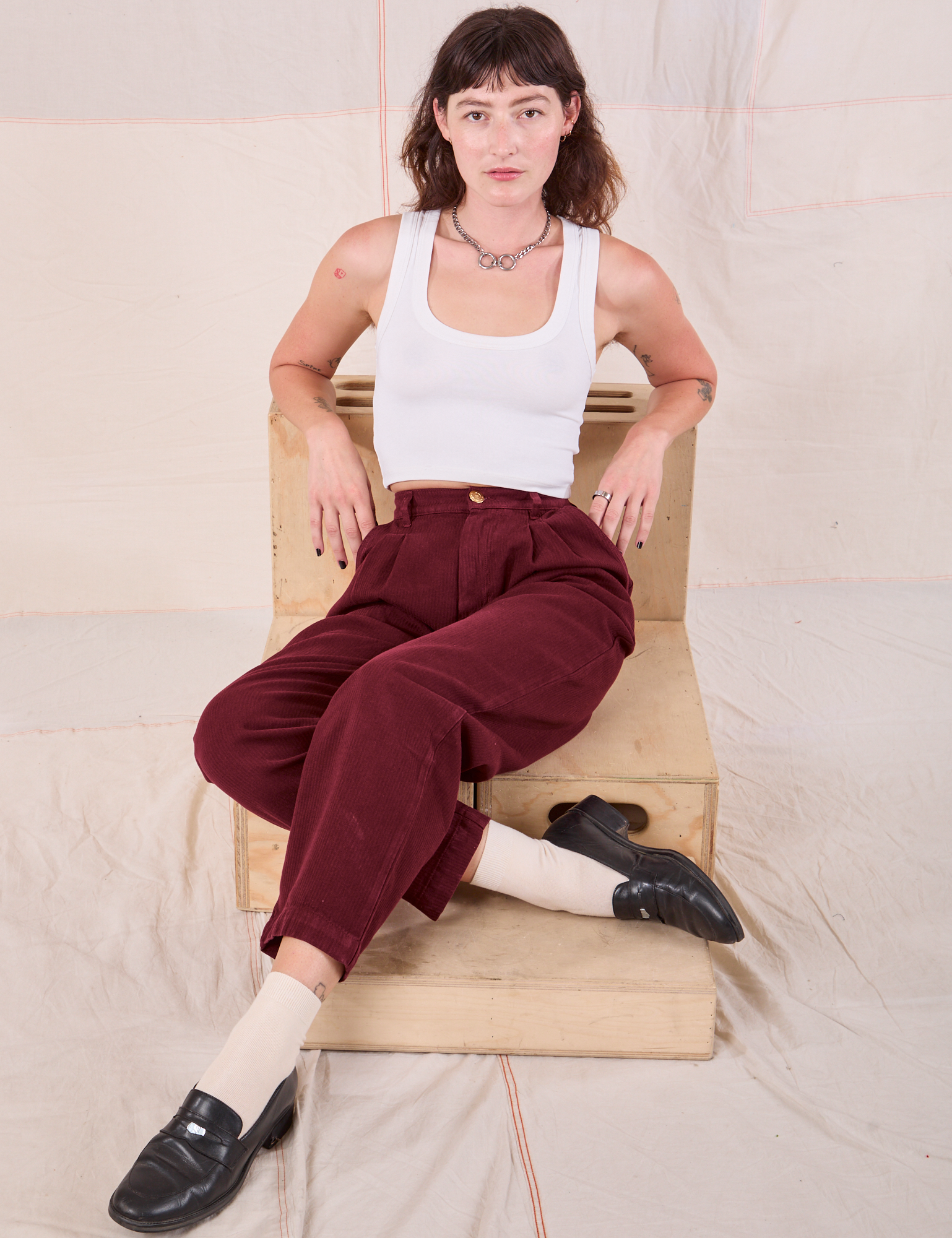 Alex is wearing Heritage Trousers in Red Wine and Cropped Tank in Vintage Tee Off-White