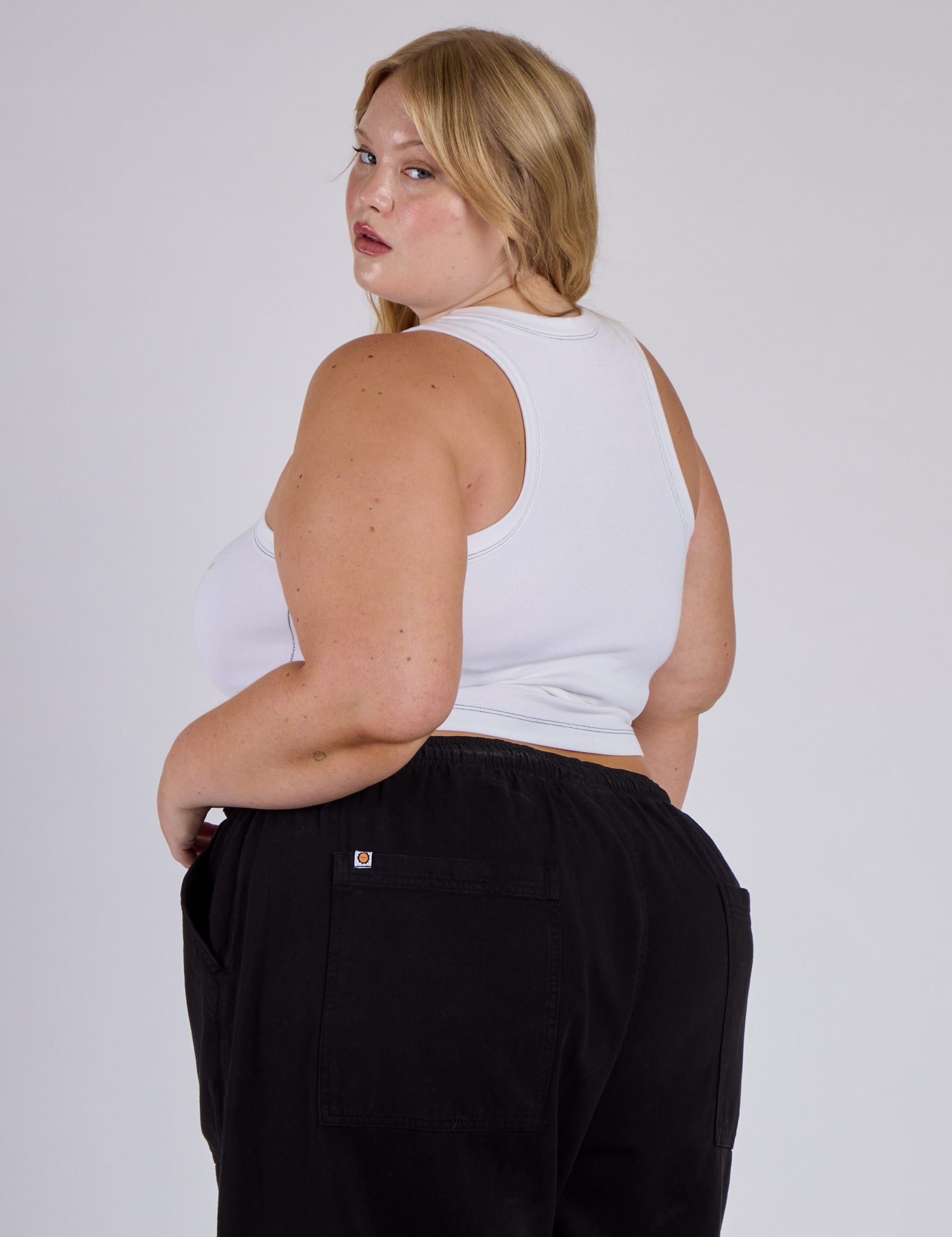 Angled view of Juliet in the Vintage Tee White Porthole Tank