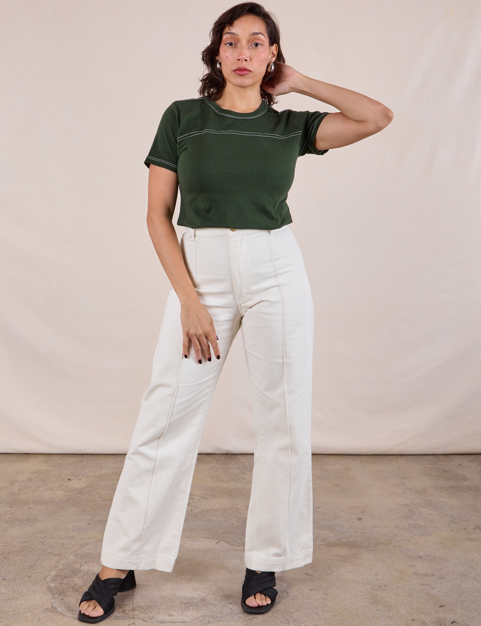 Tiara is wearing JV Tee in Swamp Green tucked into vintage tee off-white Western Pants