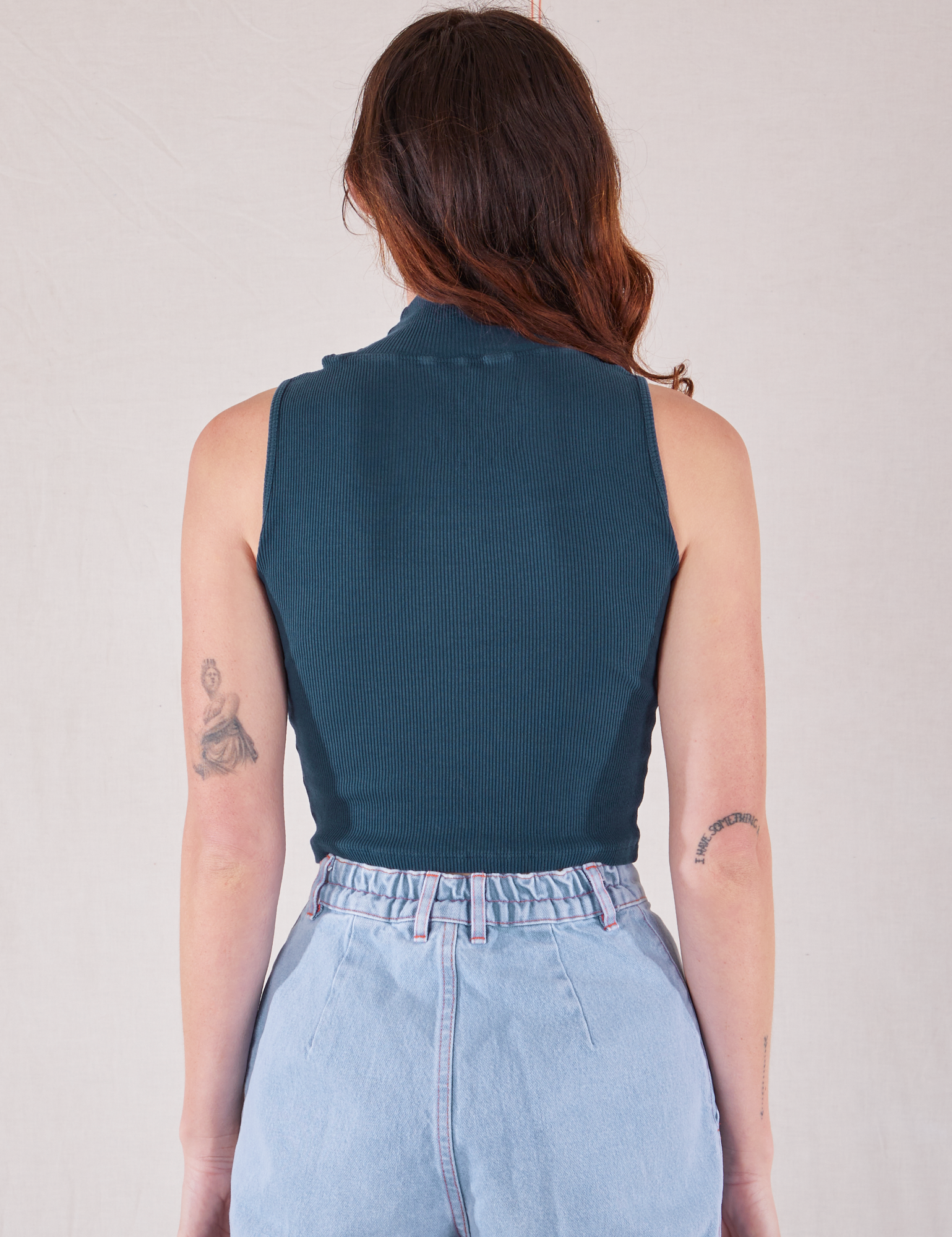 Sleeveless Essential Turtleneck in Lagoon back view on Alex