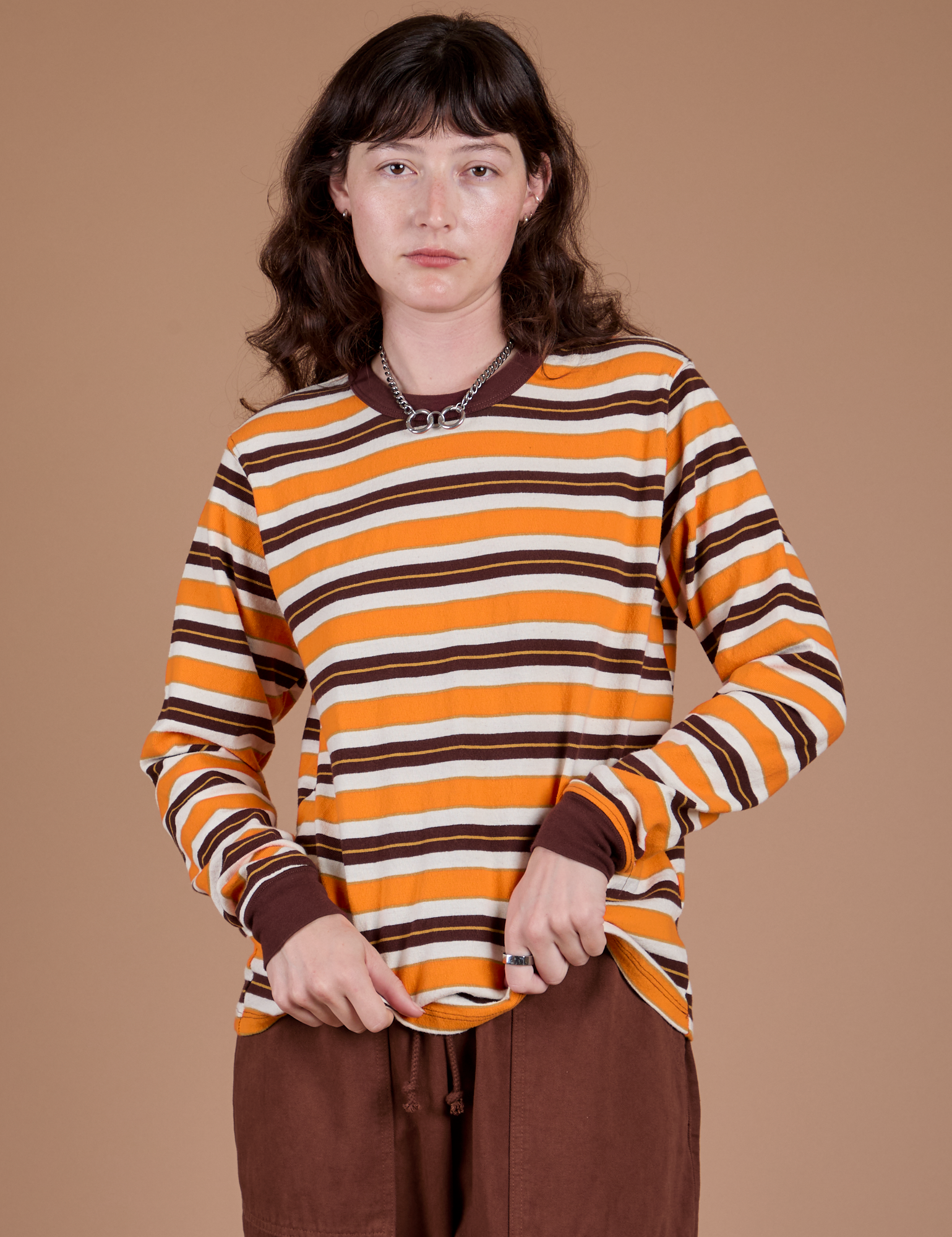 Alex is wearing Long Sleeve Striped Burly Tee in Orange