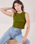 Alex is wearing Muscle Tee in Summer Olive and light wash Carpenter Jeans