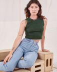 Alex is wearing Muscle Tee in Swamp Green and Carpenter Jeans in light wash