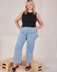 Lish is wearing Muscle Tee in Basic Black and light wash Carpenter Jeans