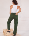 Back view of Organic Work Pants in Swamp Green and Racerback Tank in vintage tee off-white