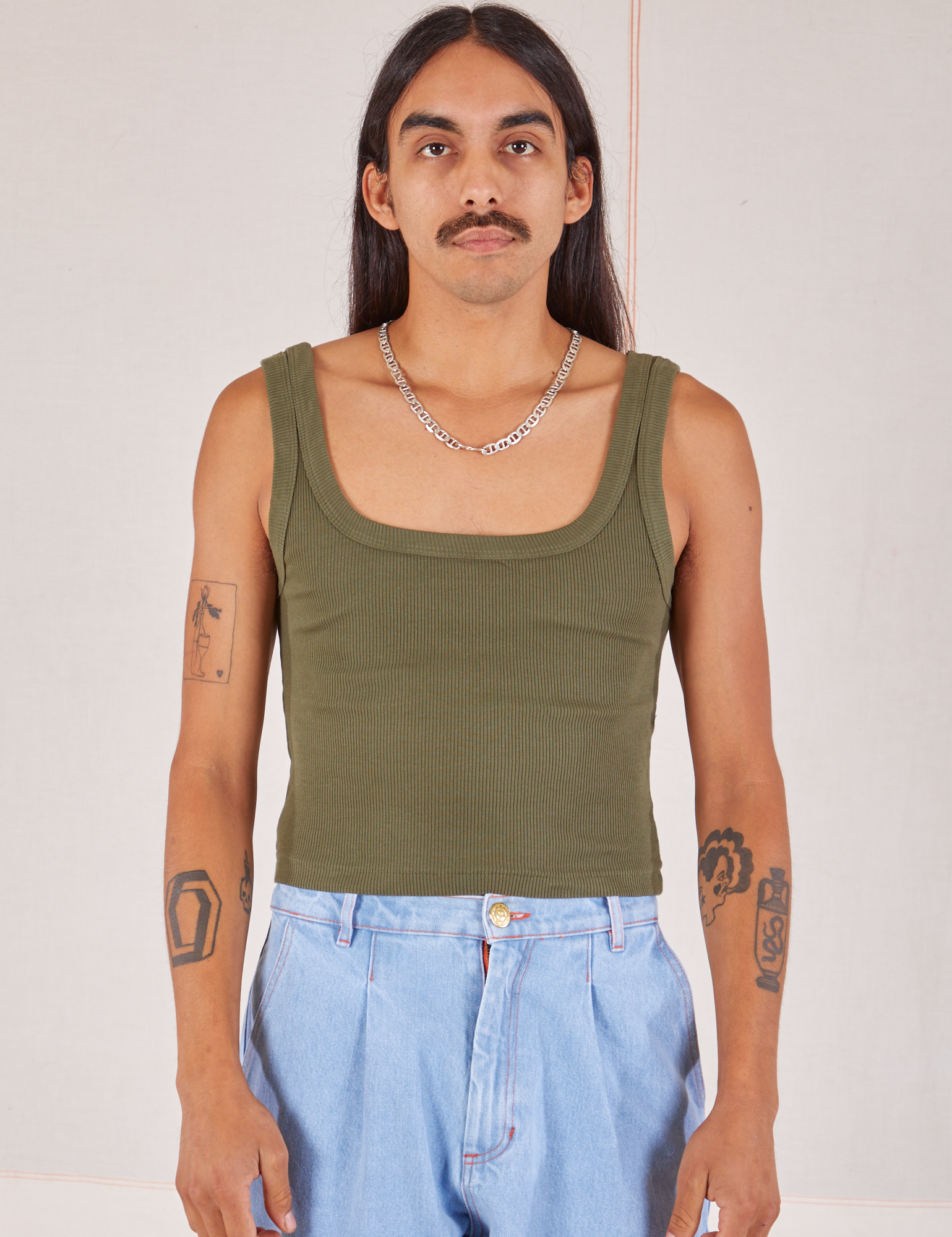 Anthony is 5’10” and wearing S Square Neck Tank in Surplus Green