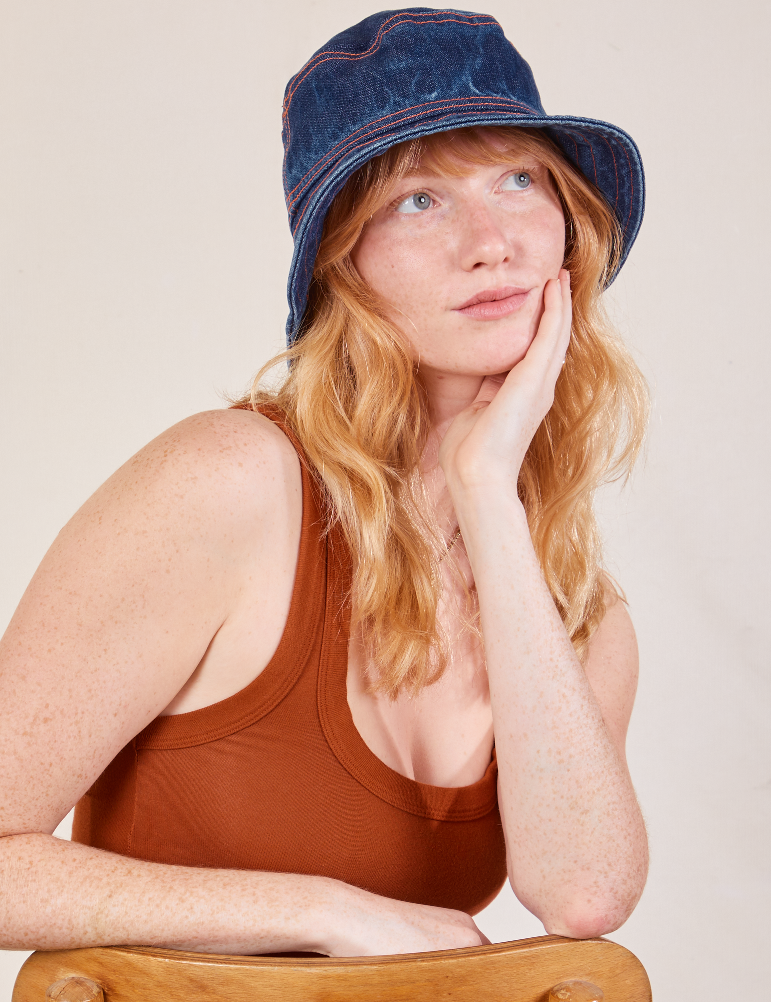 Margaret is wearing the Wide Brim Denim Bucket Hat in dark wash