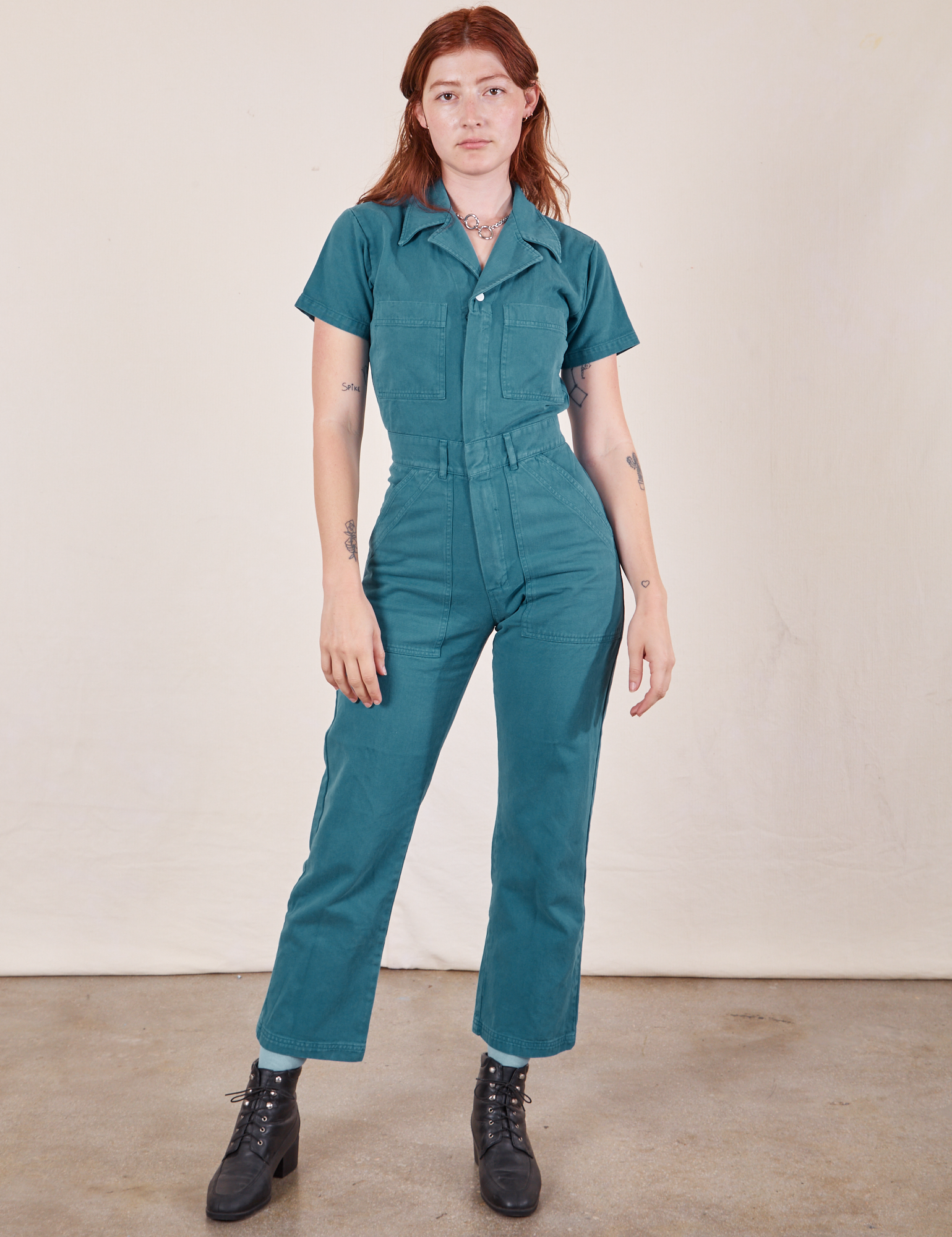 Alex is 5&#39;8&quot; and wearing XS Short Sleeve Jumpsuit in Marine Blue