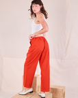 Mid-Rise Pleated Trousers in Chili Red angled back view on Alex