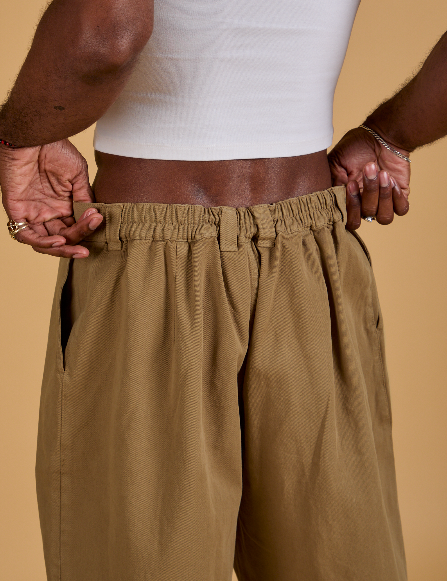 Baggy Mid-Rise Trousers in Desert Brown back close up on Jerrod