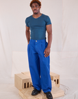 Issac is 5'10" and wearing M Mid-Rise Pleated Trousers in Royal Blue paired with lagoon Baby Tee