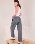 Mid-Rise Pleated Trousers in Slate Grey angled back view on Alex