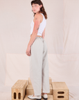 Angled back view of Mid-Rise Pleated Trousers in Stone White on Alex