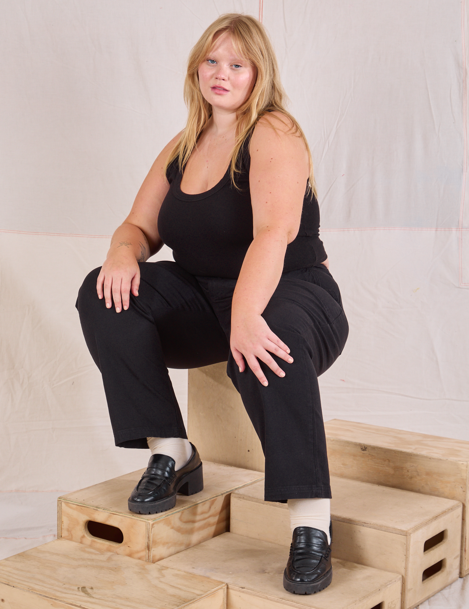 Juliet is wearing Mid-Rise Work Pants in Basic Black and black Cropped Tank