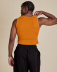 Muscle Tee in Creamsicle Orange back view on Isaac