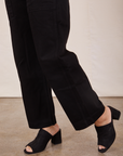Side view pant leg close up of Original Overalls in Mono Black worn by Tiara.