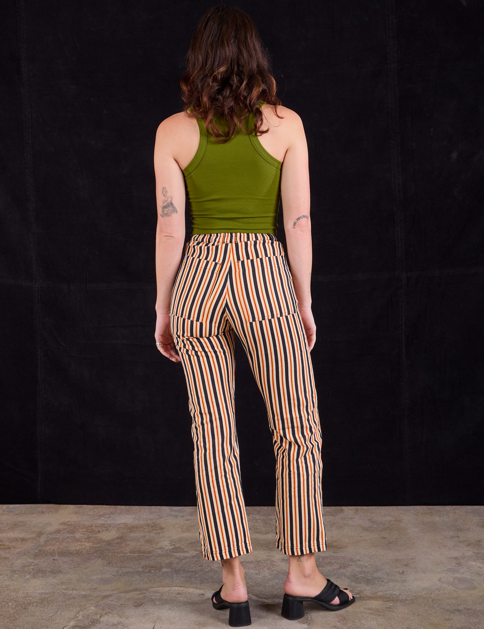 Back view of Work Pants in Autumn Stripe and summer olive Racerback Tank on Alex