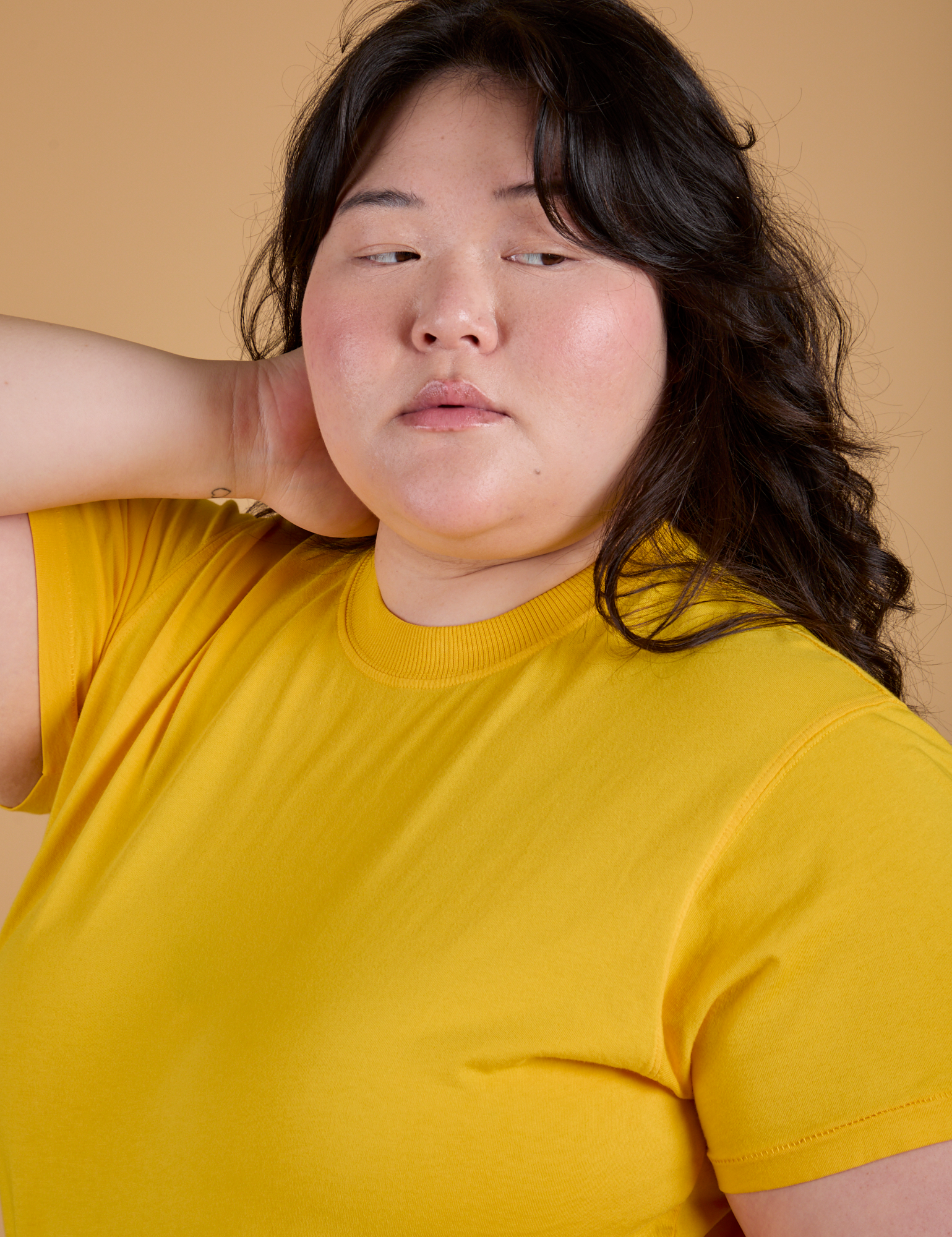 Angled front view close up of Organic Vintage Tee in Sunshine Yellow on Ashley