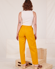 Back view of Organic Trousers in Mustard Yellow worn by Alex