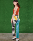 Angled back view of Mismatched Stripe Work Pants and burnt terracotta Tank Top on Alex