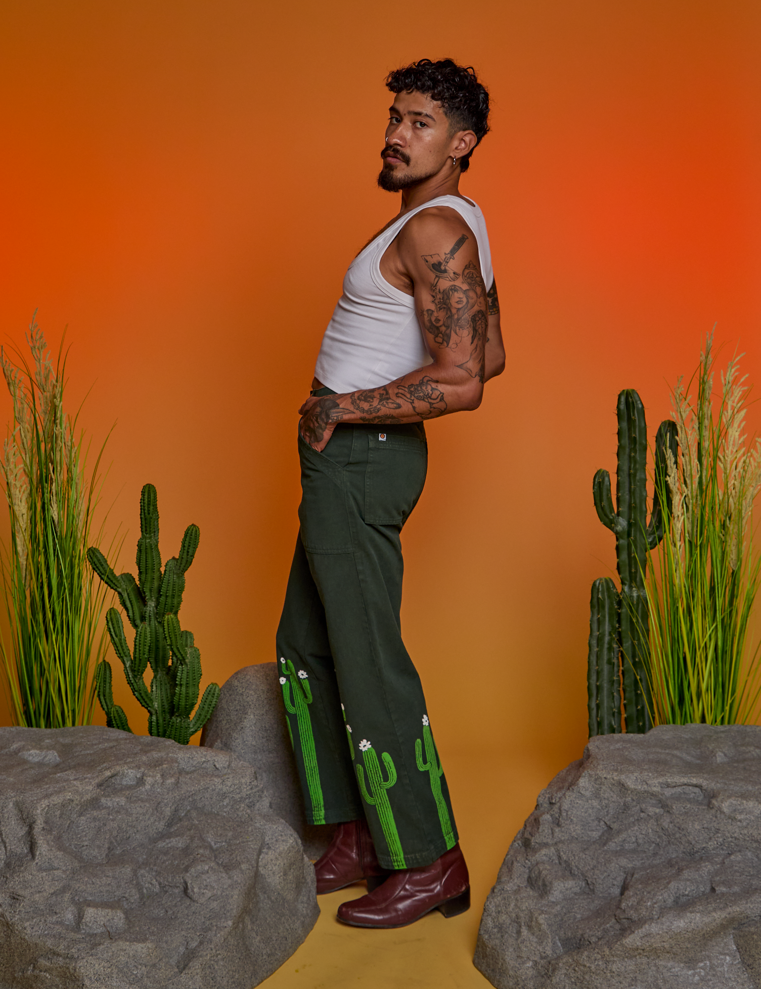 Side view of Paintstamped Work Pants in Cactus and Cropped Tank in Vintage Tee White on Jesse