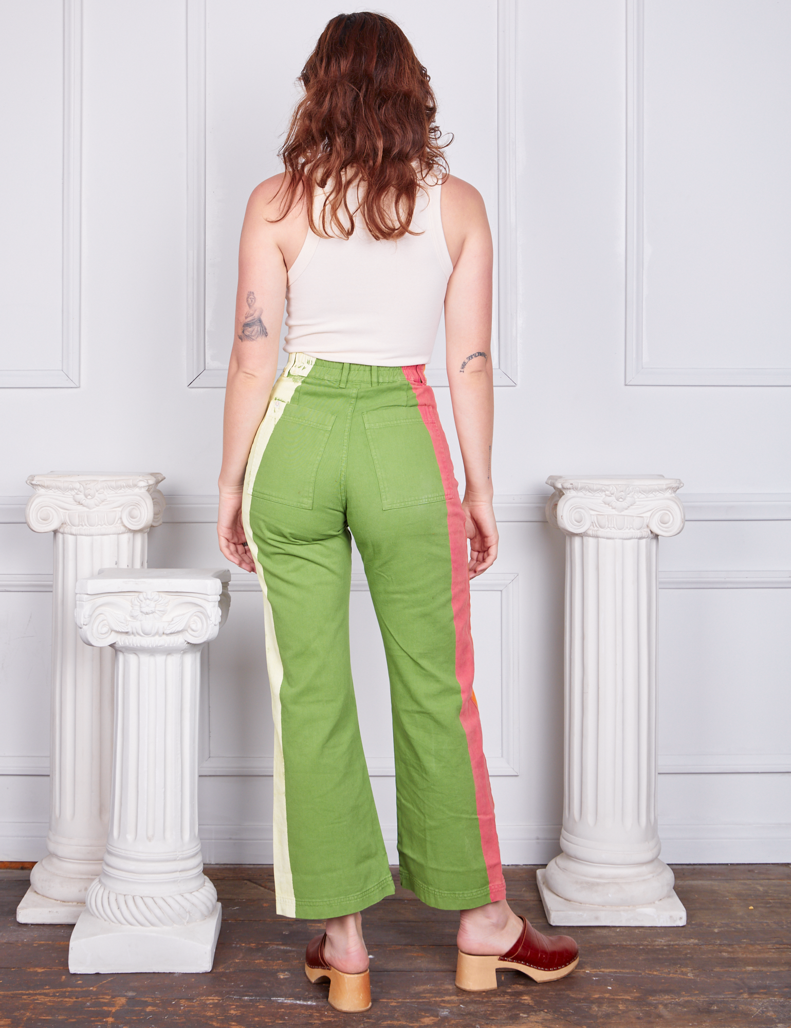 Back view of Hand-Painted Stripe Western Pants in Bright Olive and vintage off-white Tank Top worn by Alex