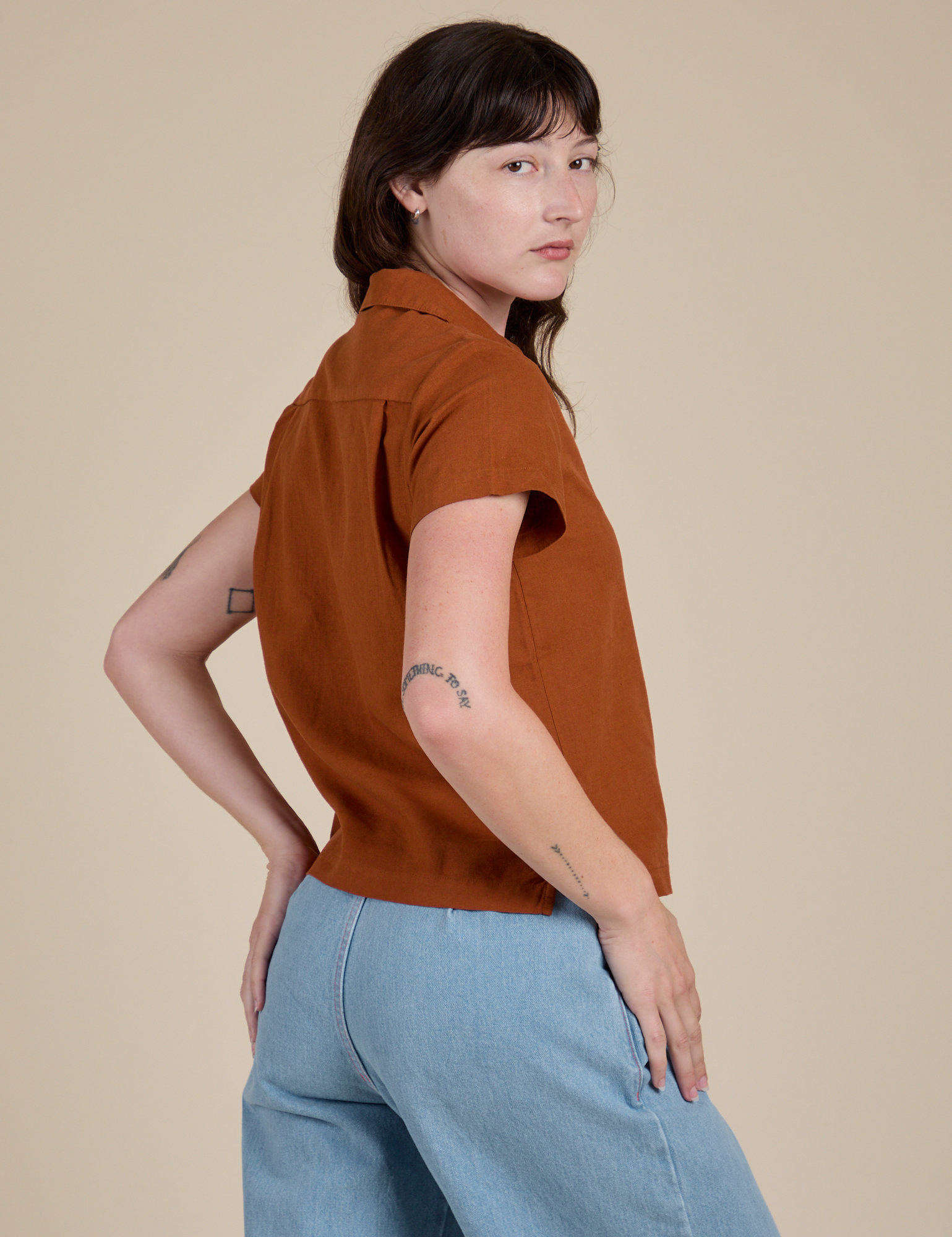 Angled back view of Pantry Button-Up in Burnt Terracotta on Alex
