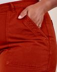 Front pocket close up of Work Pants in Paprika. Worn by Morgan with her hand in the pocket.