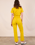 Short Sleeve Jumpsuit in Golden Yellow back view on Alex