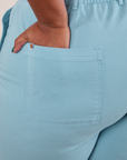 Close up of Morgan's hand in the back pocket of Work Pants in Baby Blue