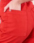 Close up of Alex's hand in the back pocket of Work Pants in Mustang Red