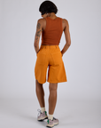 Back view of Longline Work Shorts in Creamsicle Orange and burnt terracotta Cropped Tank