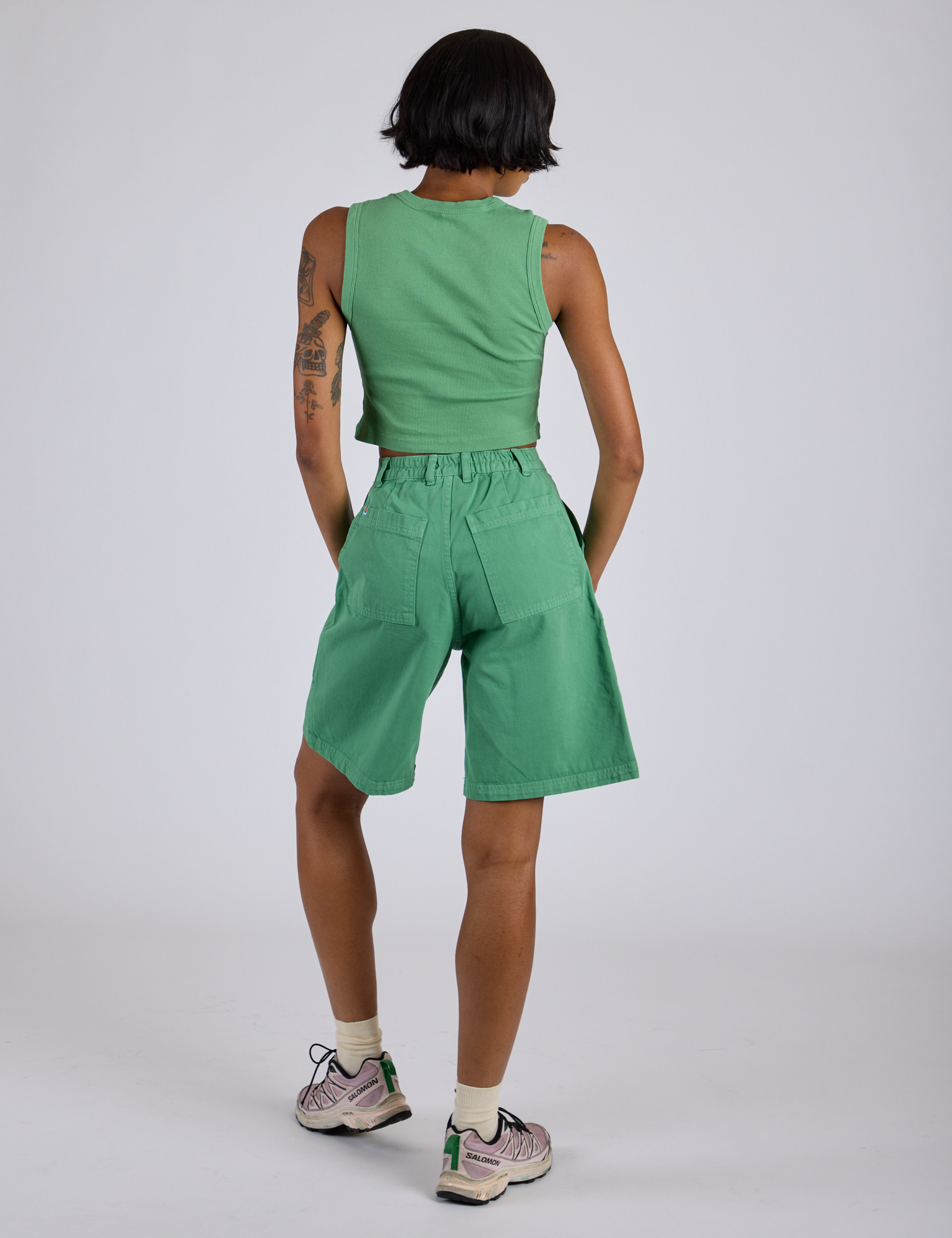 Back view of Longline Work Shorts in Seafoam Green and matching Muscle Tee on Kira