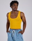 Isaac is 5’10” and wearing M Cropped Tank Top in Sunshine Yellow