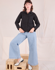 Alex is wearing a buttoned up Ripstop Work Jacket in Basic Black paired with Wide Leg Denim Trouser Jeans in lightwash