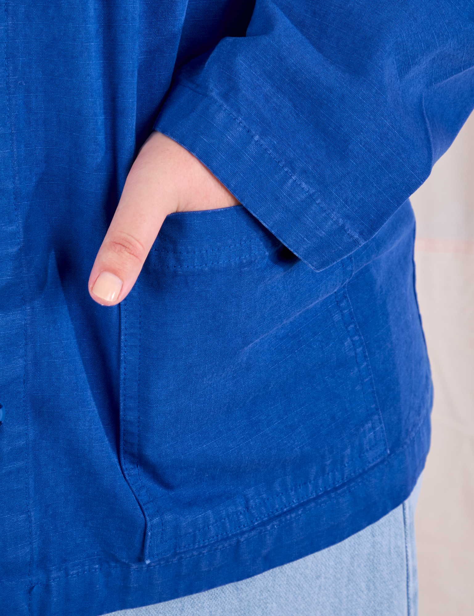 Ripstop Work Jacket in Royal Blue front pocket close up. Juliet has her hand in the pocket.